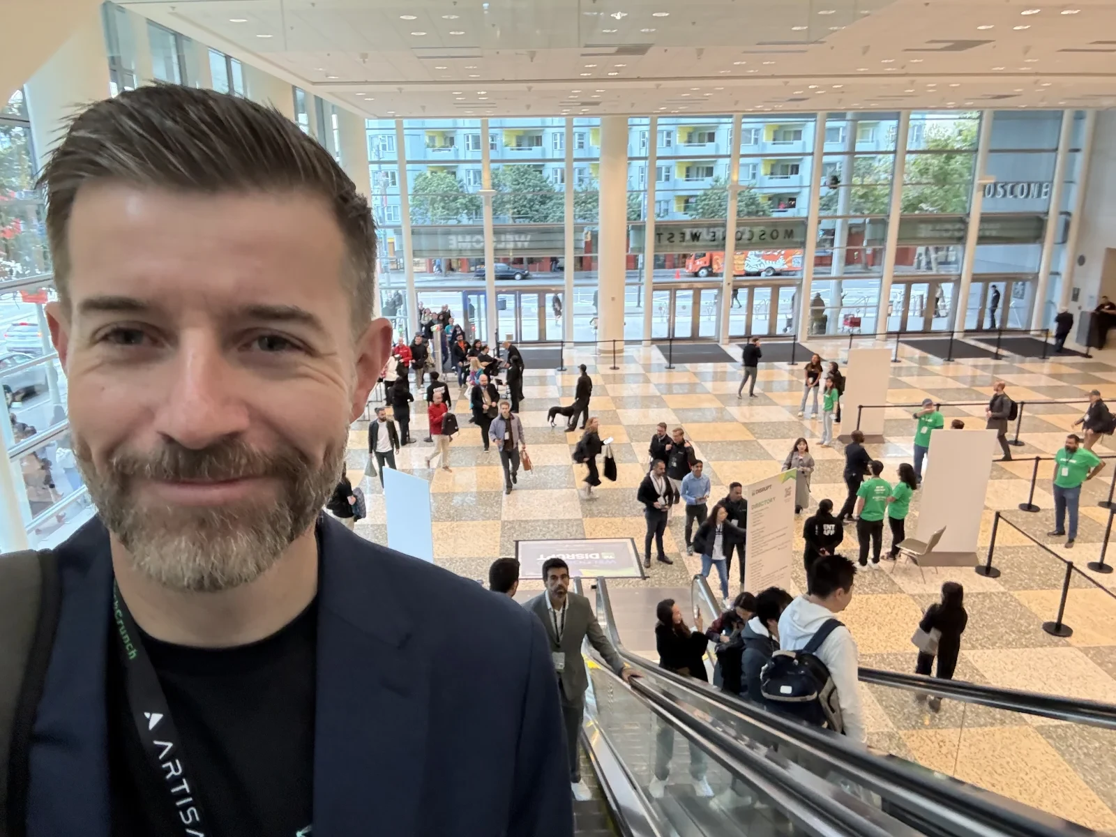 Trever Jackson at TechCrunch for the Morph.Systems launch, with the event hall behind him